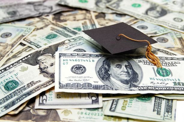 photo showing graduation cap on top of $100 bills.