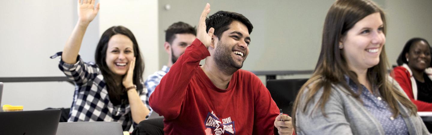 Students raising their hands in a Public Policy class.