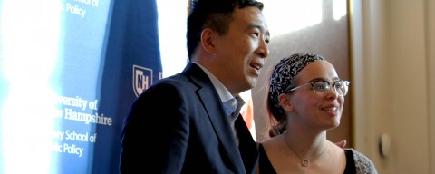 Andrew Yang standing with a student.