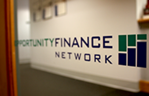 A sign with the opportunity finance network logo showing on it
