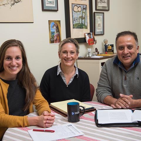 Members of the Carsey School recruitment team sitting around a table and smiling.