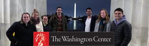 A photo of six Carsey School Master in Public Policy students standing in front of the Washington Monument with The Washington Center logo in front of them