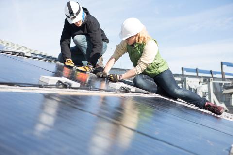 Female worker installing roof