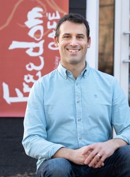 Bryan Bessette in front of The Freedom Cafe.