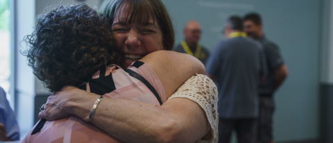 two women embracing eachother in a hug