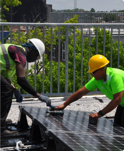 two men working on solar panel