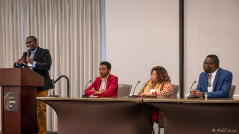 MCD alum Jean Hakuzimana speaking at a community development conference