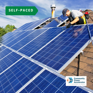 solar worker installing panels on a community building roof
