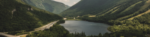 view of lake surrounded by new hampshire white mountains