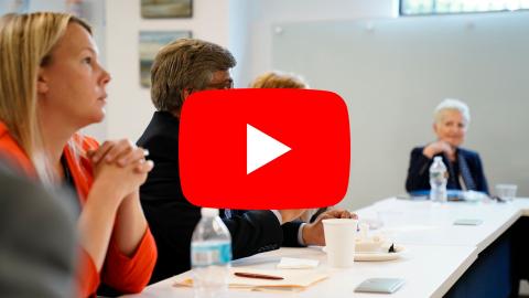 public service professionals sitting at a table listening