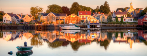 New Hampshire beach town coast with a boat floating in the water