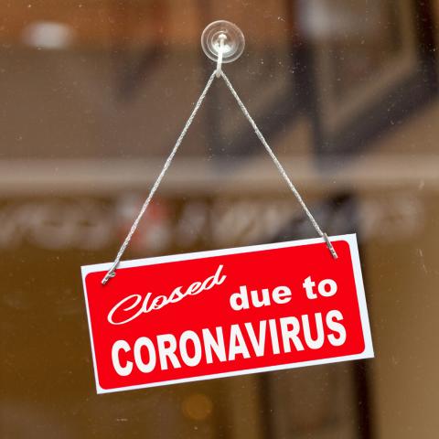 A photograph with a sign on the door reading Closed due to Coronavirus