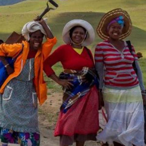 Three african women walking to a Sustainable Microfinance conference