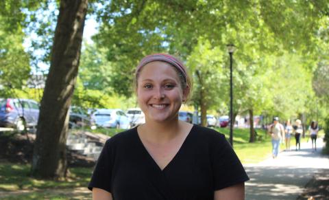 Photo of Jordyn Kafka standing in front of Huddleston Hall at UNH Durham