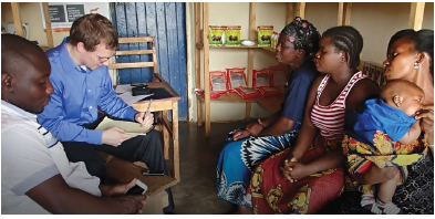 UNH student Abraham DeMaio interviews farmers with Ziweto co-founder Byton Simwela.