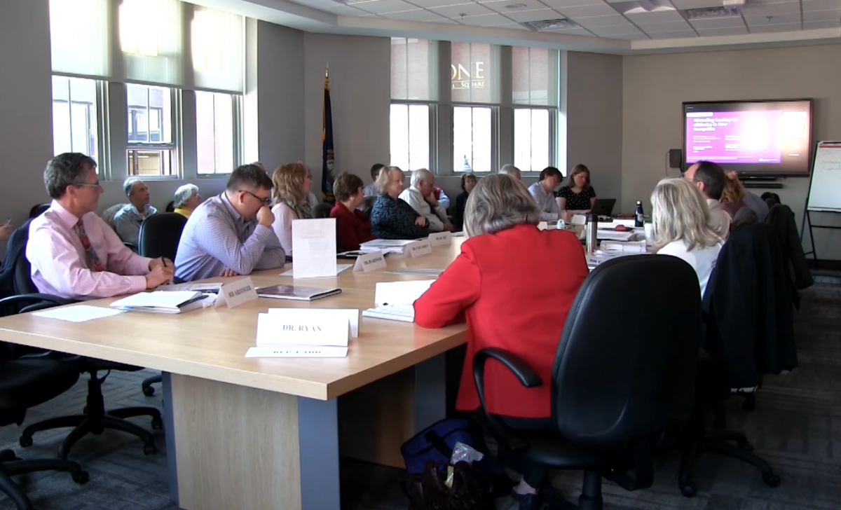 New Hampshire School Funding Commission Members sit around a Conference Table