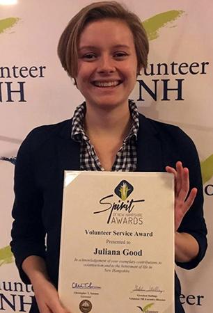 Accelerated Masters student Juliana Good holding her Spirit of New Hampshire Award