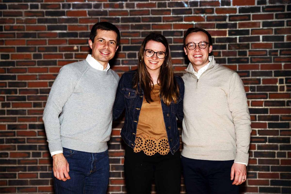 A photo of Sarah Nadeau standing with Pete and Chasten Buttigieg