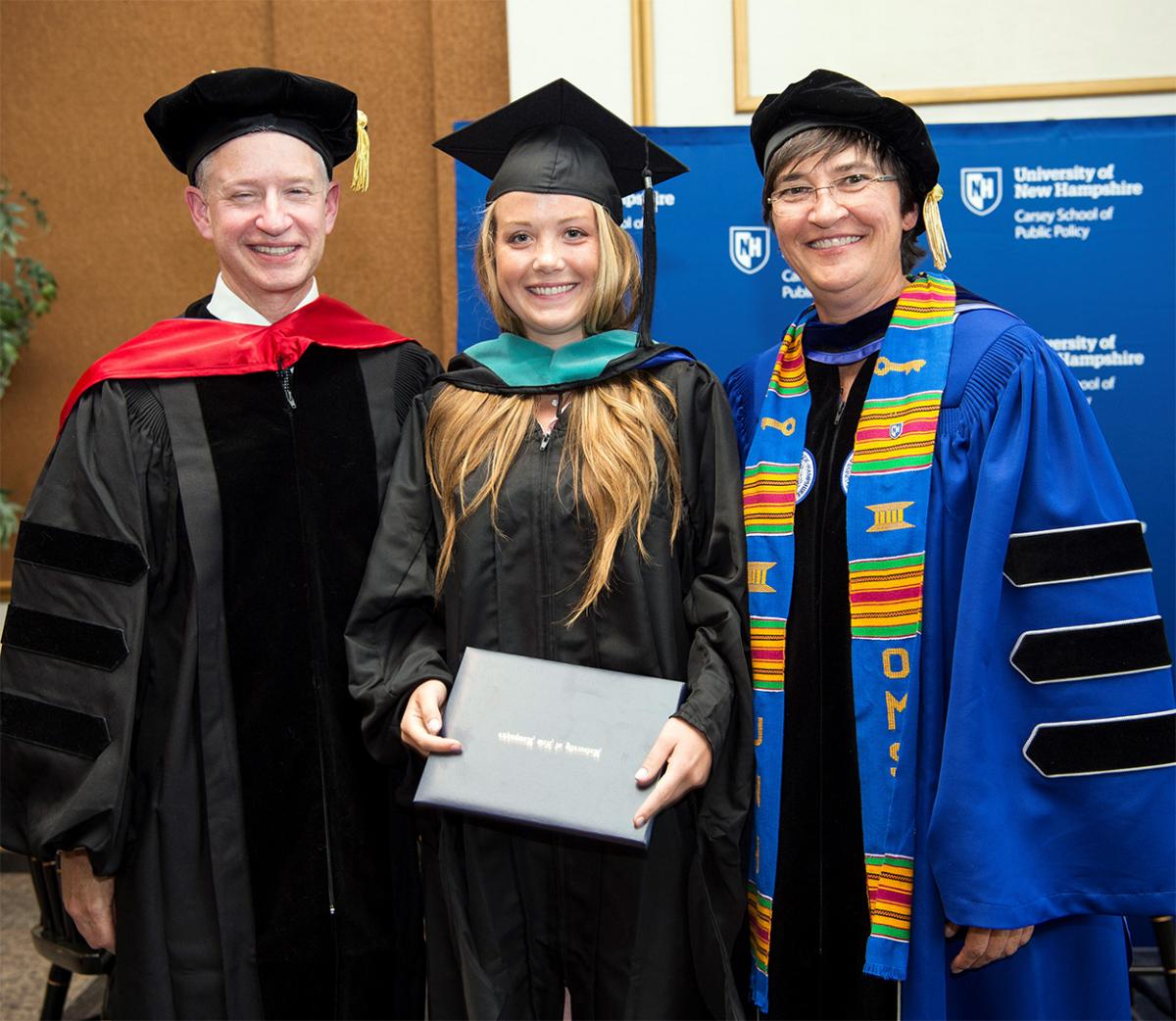 A photo of, from left, Michael Ettlinger, Kennedy Nickerson, and UNH Graduate School Dean Cari Morehead