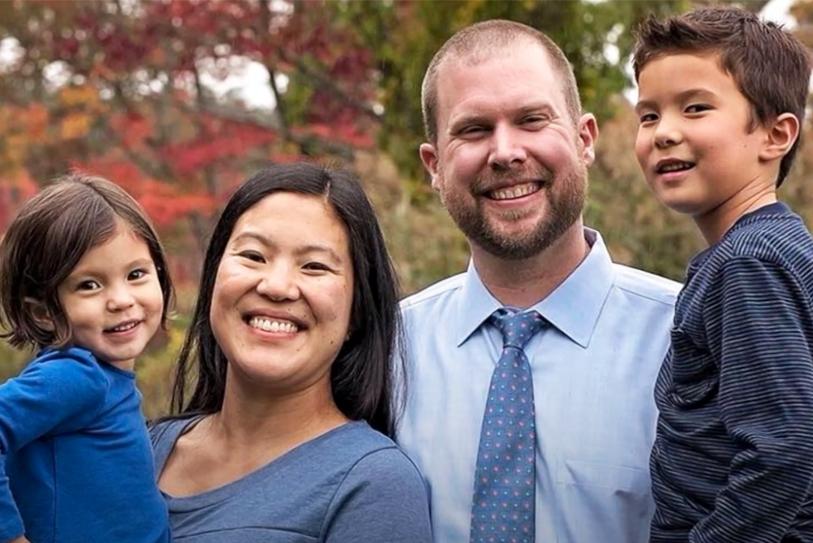 Photo of Carsey School alumni Matt Wilhelm (second from right) standing with his wife and two children.
